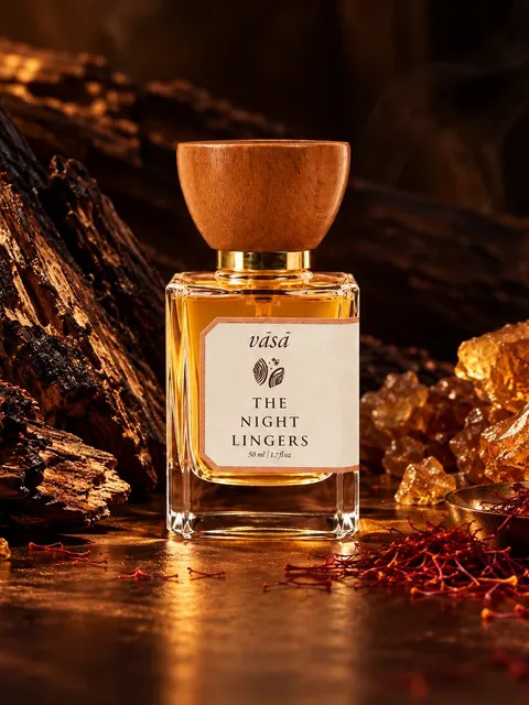 The Night Lingers beside oud wood, amber resin and saffron threads in warm low light